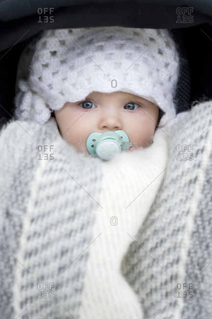 A baby wrapped in a blanket, portrait