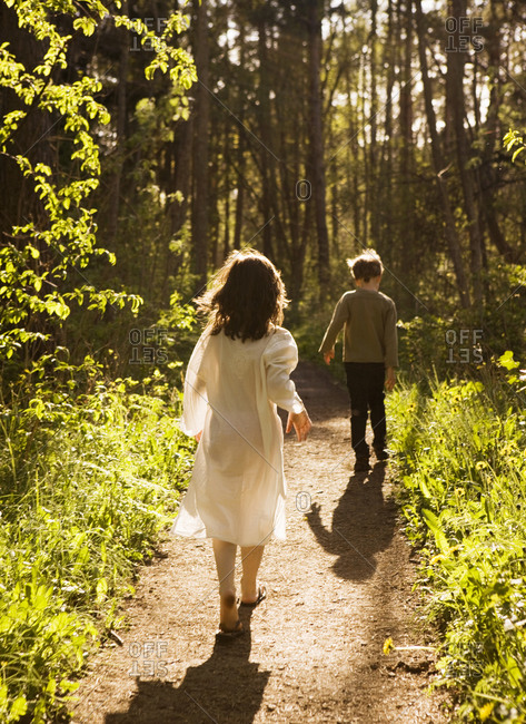 A girl and a boy walking in the forest,  Sweden