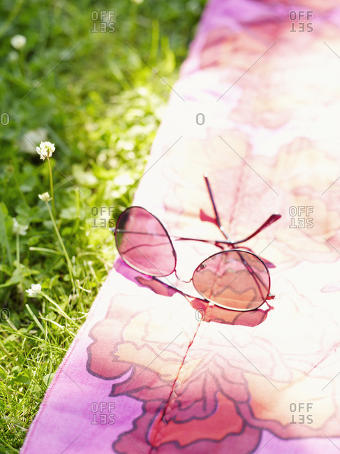 Sunglasses on a blanket in the grass
