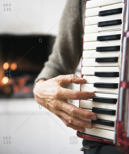 A hand playing on an accordion, close-up.