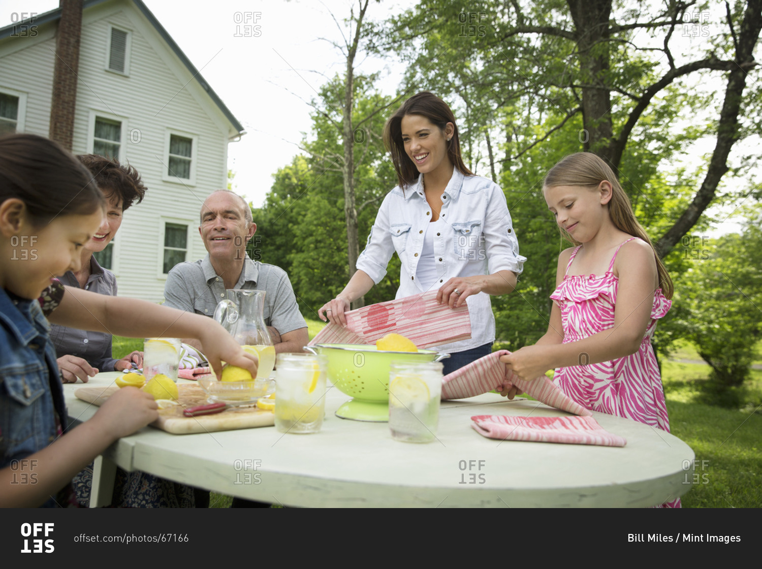 A family group making fresh lemonade
