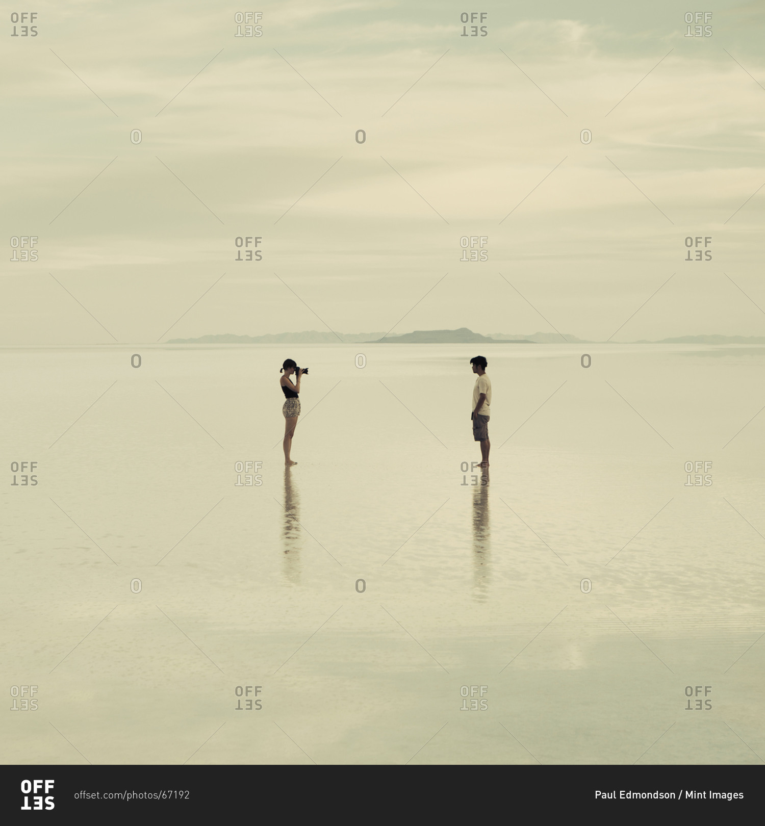 Man and woman standing on the flooded Bonneville Salt Flats