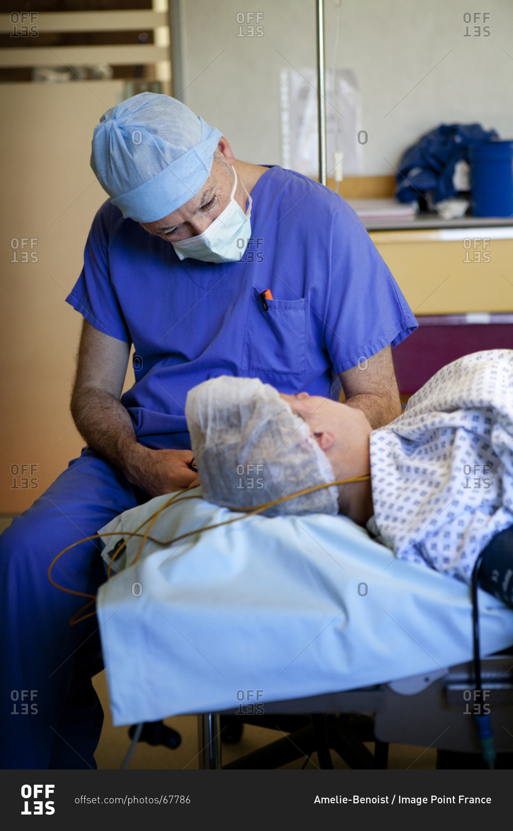Anesthesiologist communicating with patient to ensure patient maintains hypnotic state during cesarean section