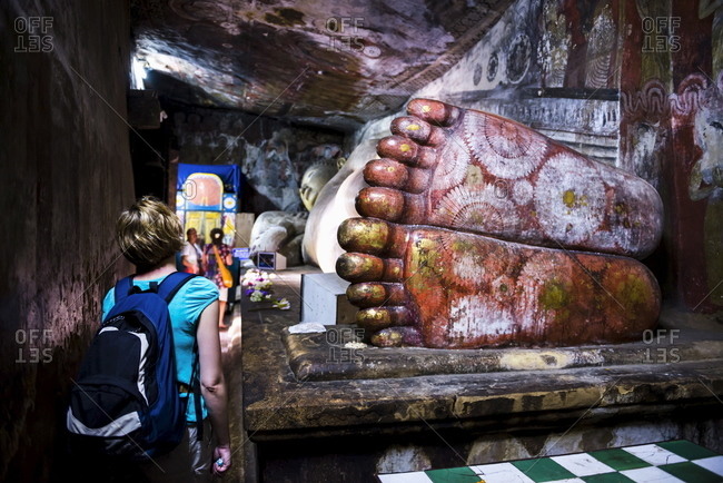 March 7, 2017: Tourist visiting Cave 1 (Cave of the Divine King), Dambulla Cave Temples, UNESCO World Heritage Site, Dambulla, Central Province, Sri Lanka, Asia