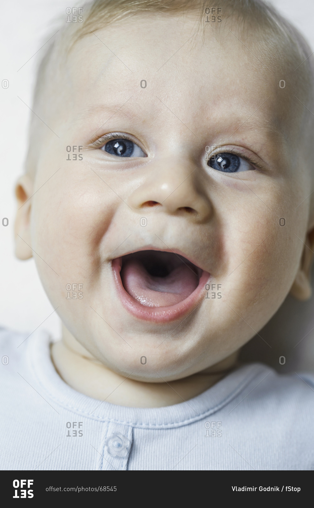 a-baby-boy-smiling-and-looking-up-stock-photo-offset