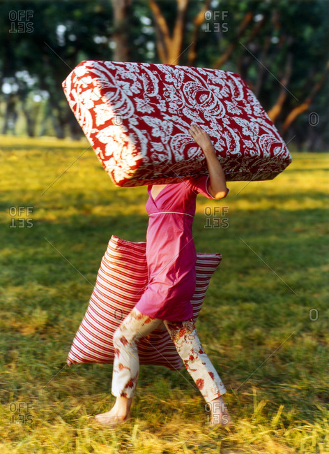 Woman carrying huge cushions
