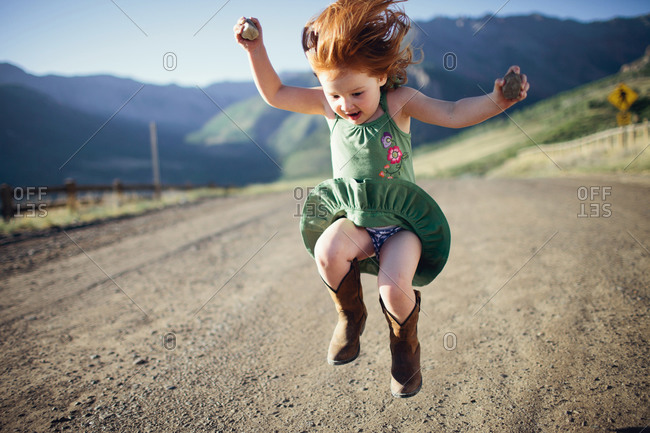 Little girl wearing blue panties with pink hearts stock photo - OFFSET