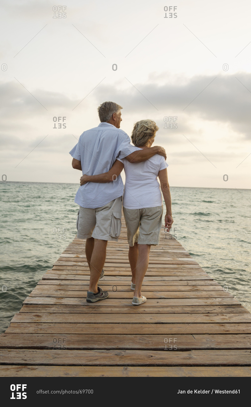 Spain, Senior couple standing on jetty at the sea
