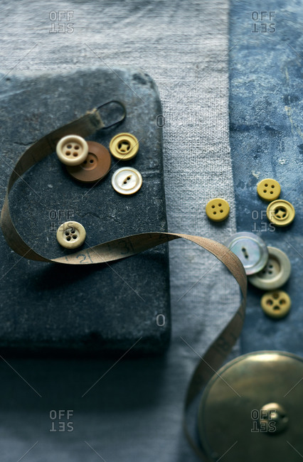 Top view of vintage buttons and measuring tape