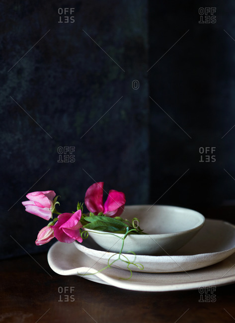 Three dishes with pink flower