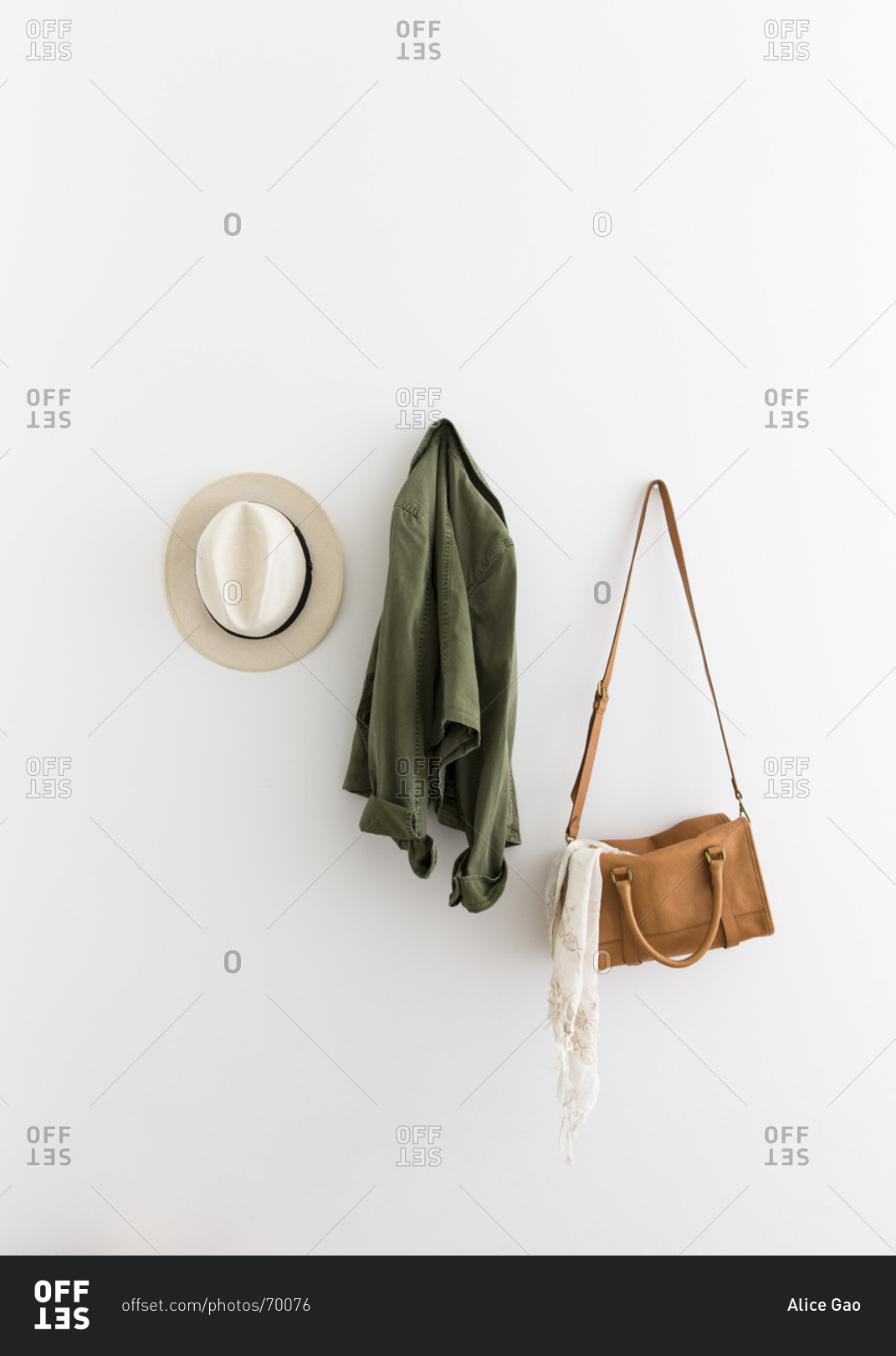 Female accessories and jacket hanging on wall