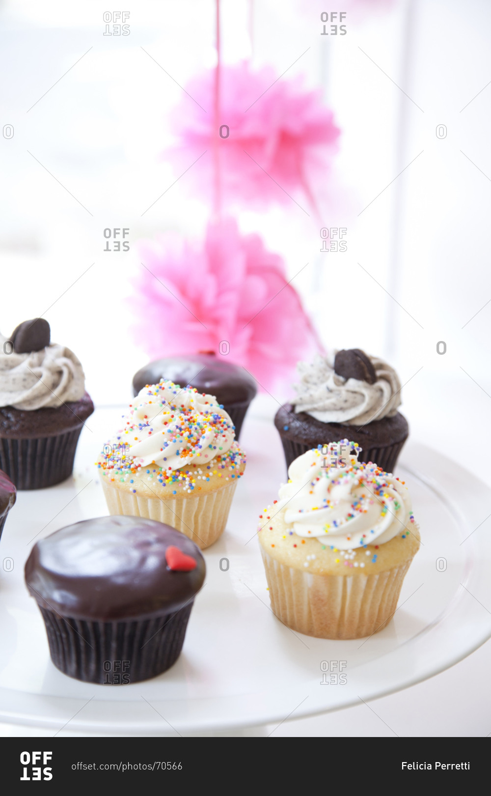 Still life of three different cupcakes on cake stand
