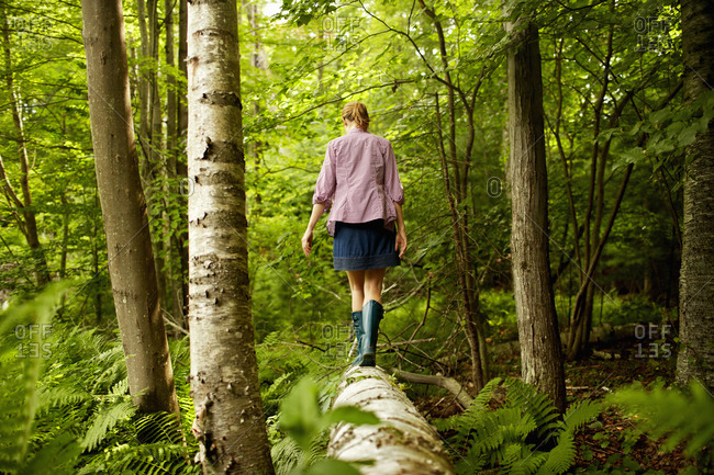 Young woman walking in forest alone