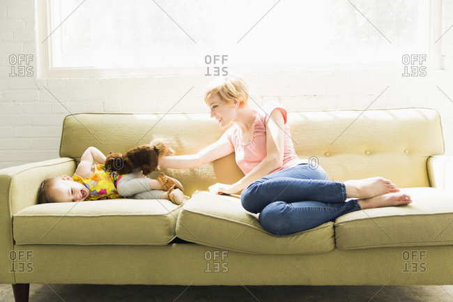 Mother playing with baby daughter (12-17 months)