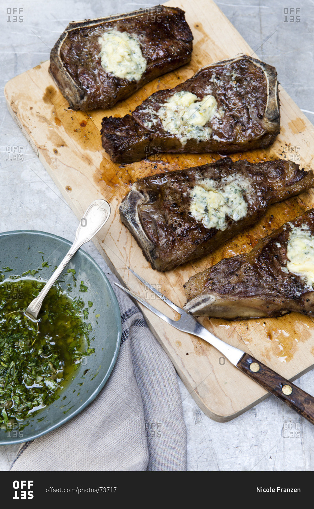 Grilled strip steaks with blue cheese butter and salsa verde stock