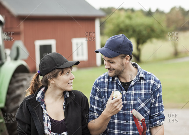 Mid adult couple looking at each other on farm
