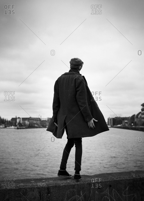 Person standing on the edge of a bridge