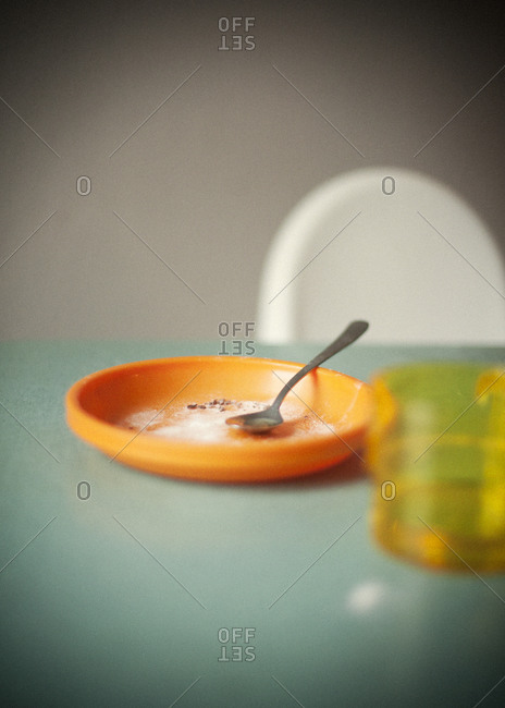 Still life of plastic plate and glass on dining table
