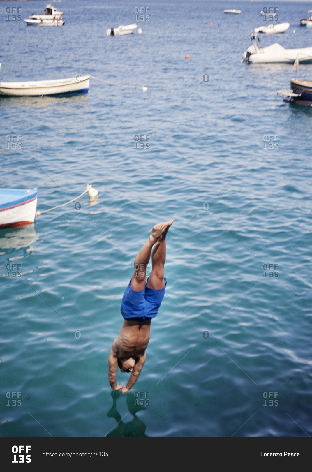 Athletic man diving into the sea