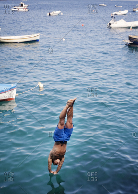 Athletic man diving into the sea