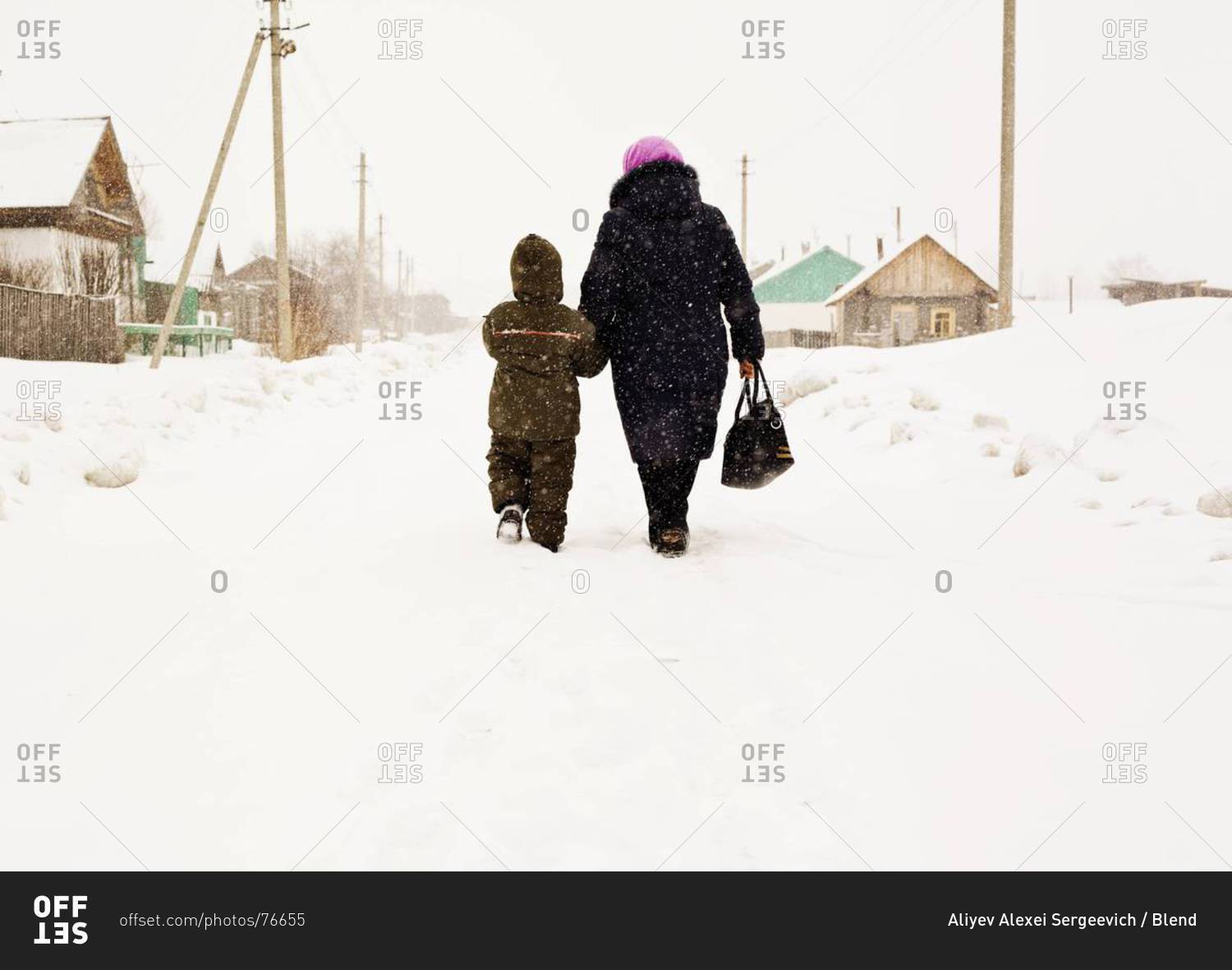 Mother and son walking in snow