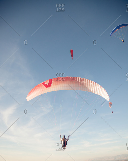 Peaceful landscape with parachuters in the air
