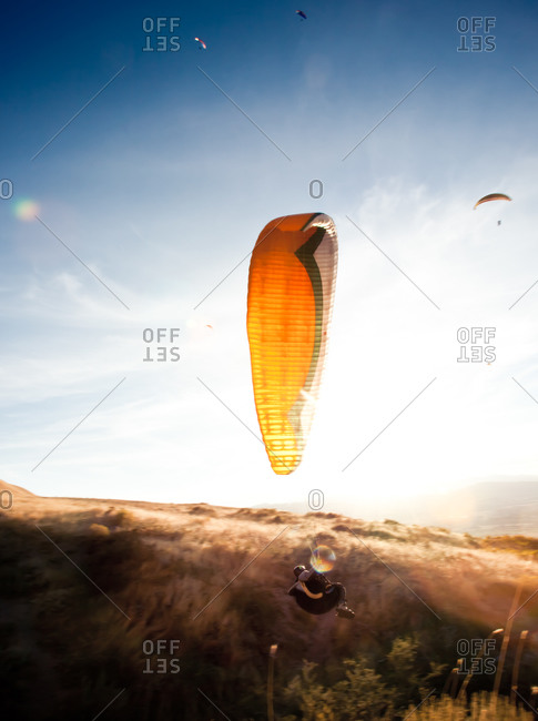 Peaceful landscape with parachuters