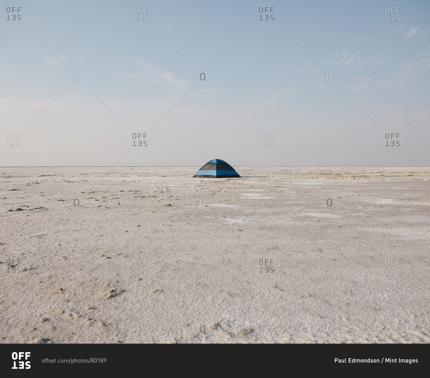 A blue tent on Bonneville Salt Flats at dusk.