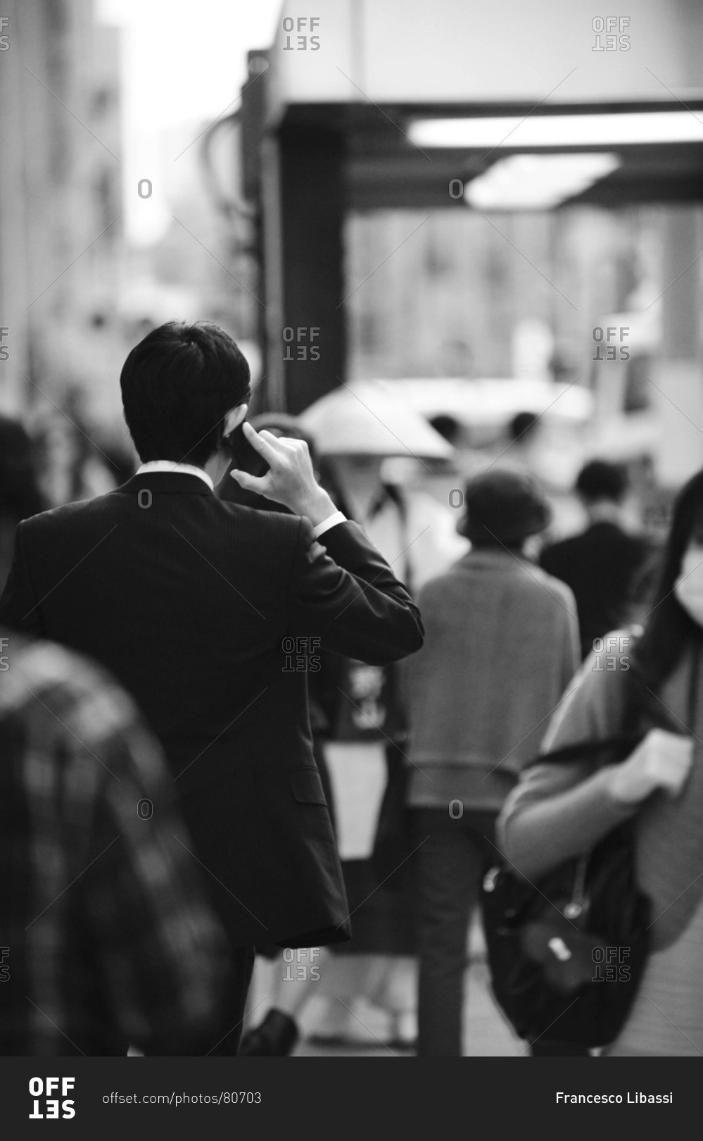 Back view of businessman talking on his cell phone, Ginza district in Tokyo, Japan