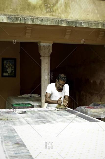 Indian man hand block prints on textile