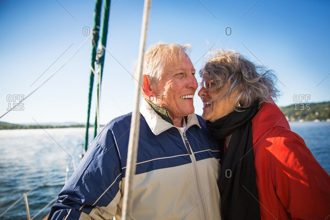 Mature couple enjoy sailing and each other