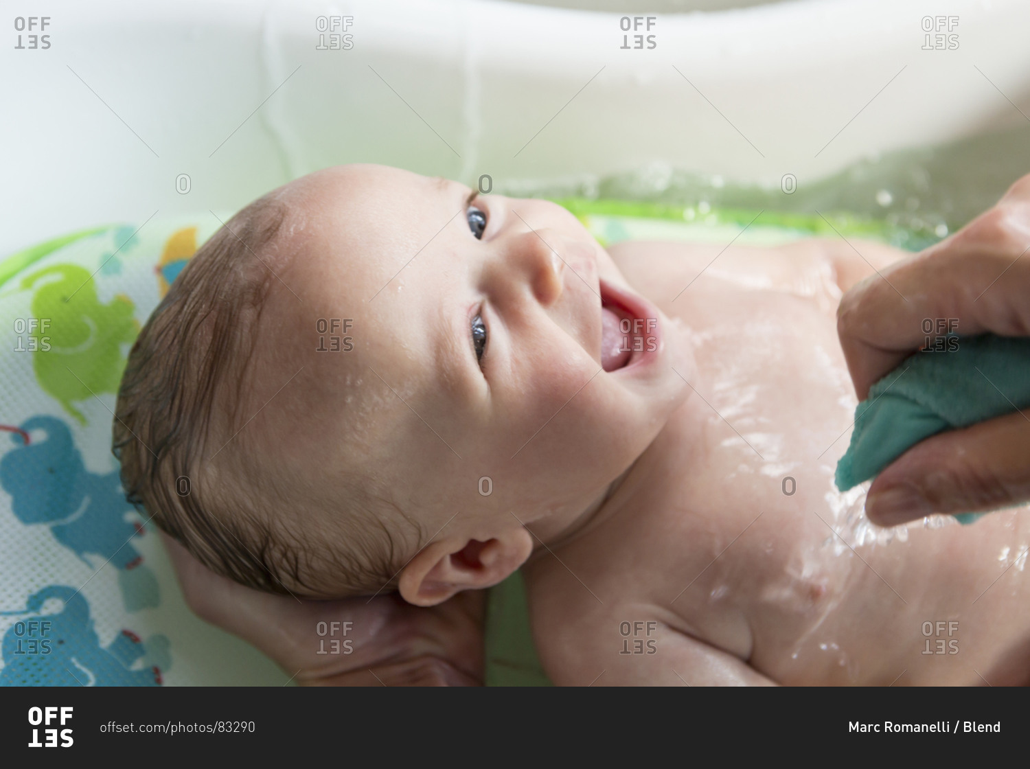 Mother giving baby boy a bath