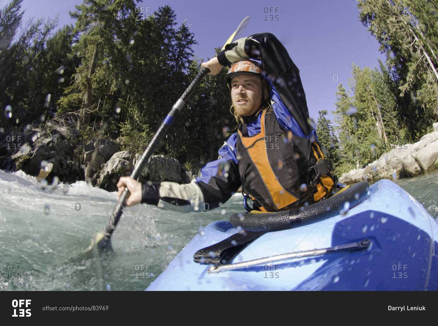 Man kayaking rough waters