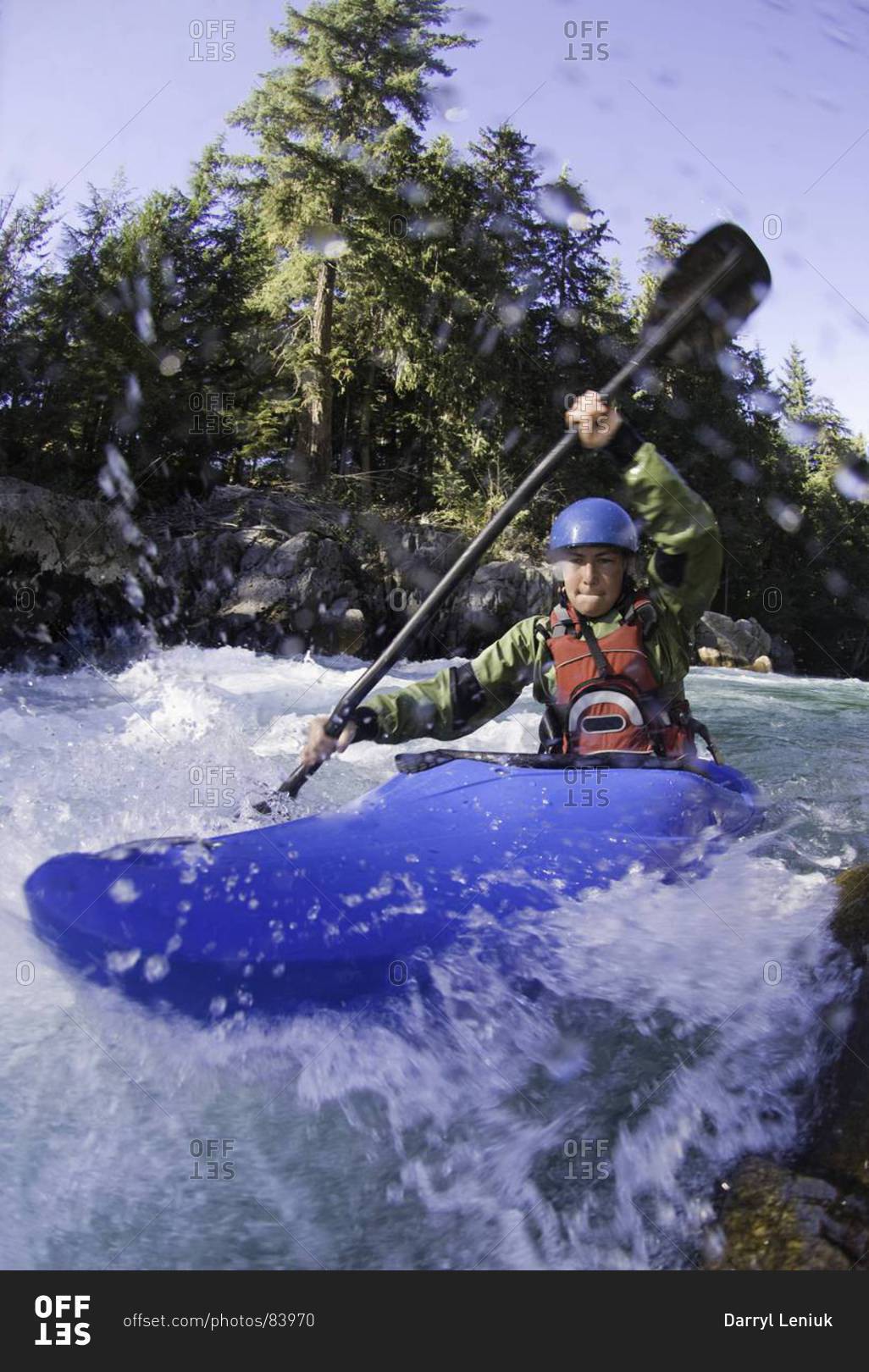 Woman kayaking rough waters