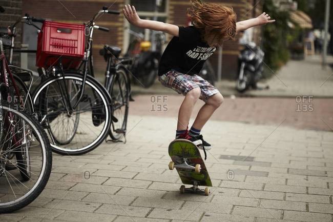 Young boy skateboarding on the street