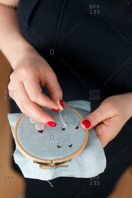 Hands of woman embroidering