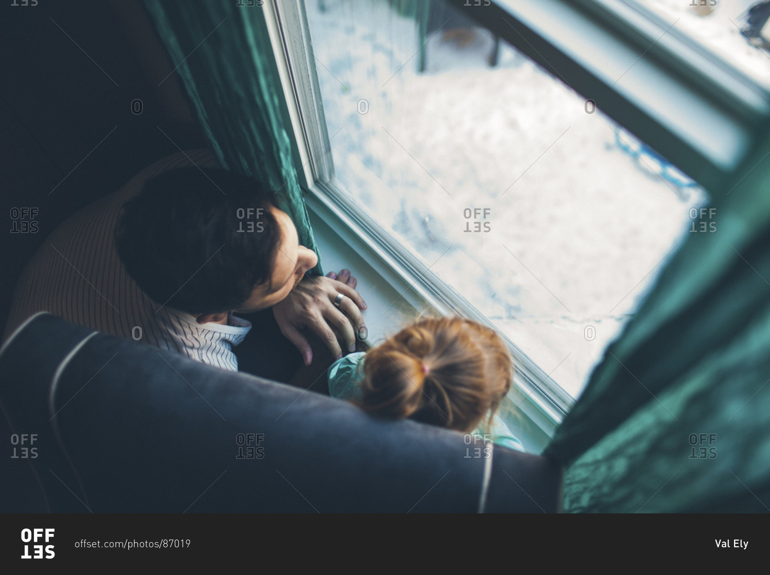 Man looking at window together with young girl