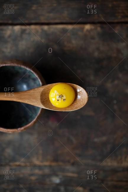 Egg yolk on a wooden spoon