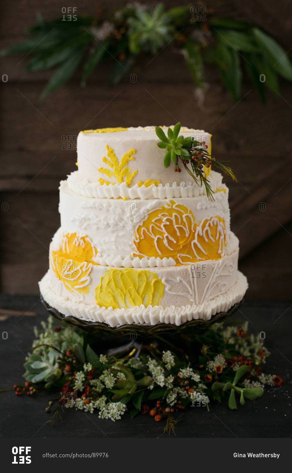 Layered cake decorated with yellow flower pattern