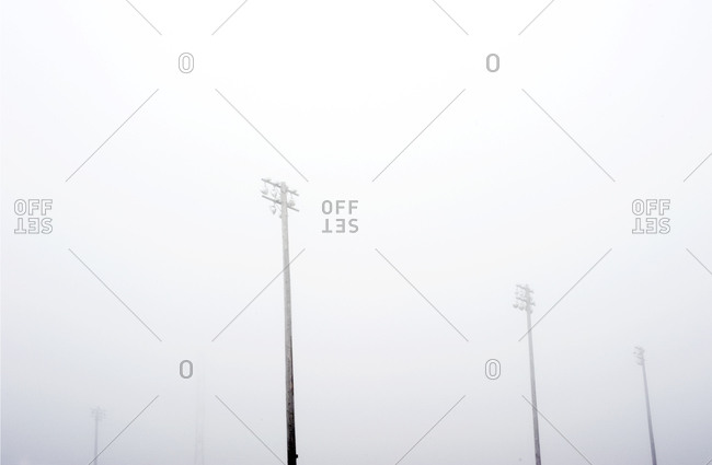 High mast lighting poles disappear on a foggy day,