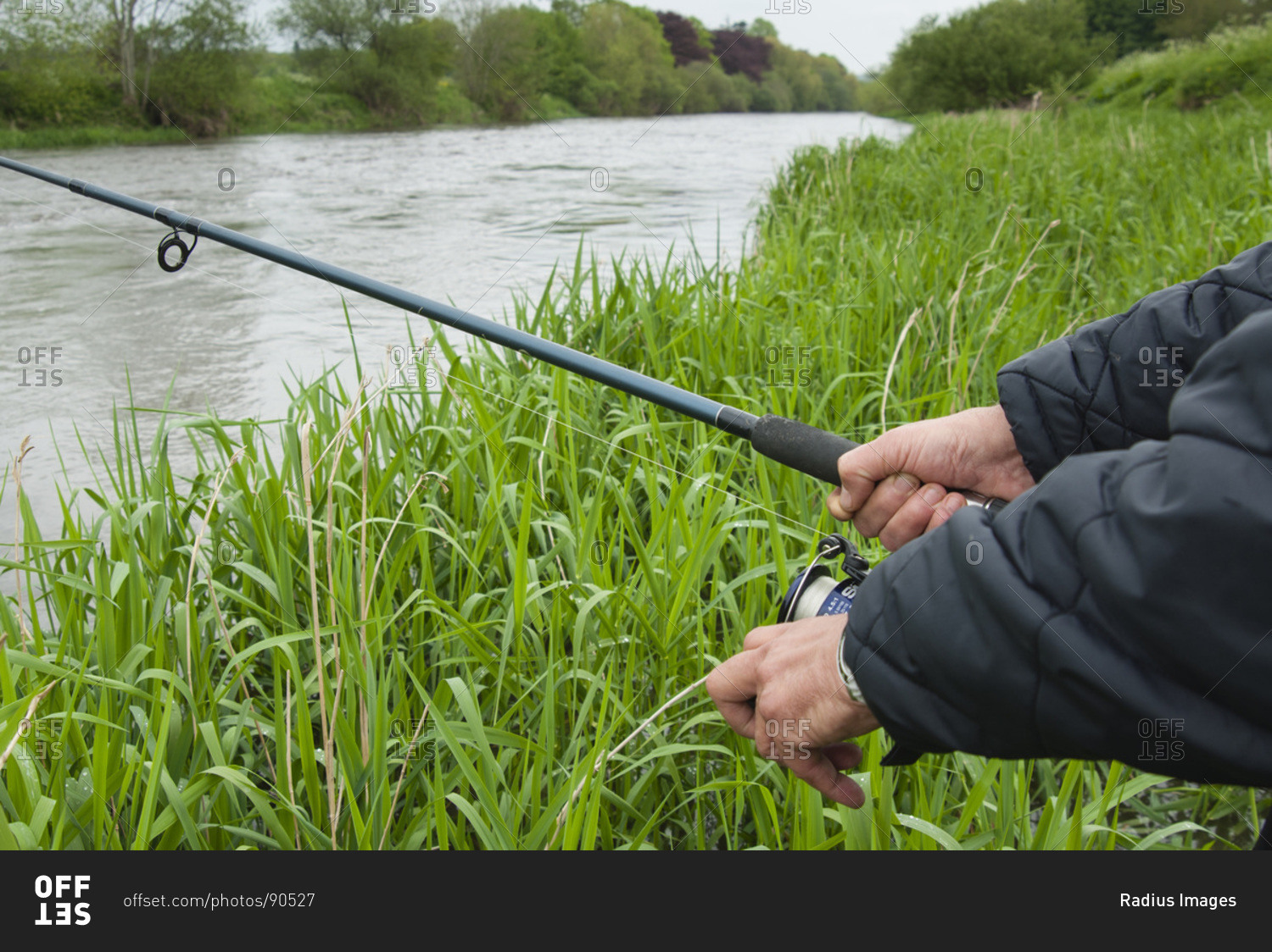 Closeup of man fishing at river Nore, Thomastown, County Kilkenny