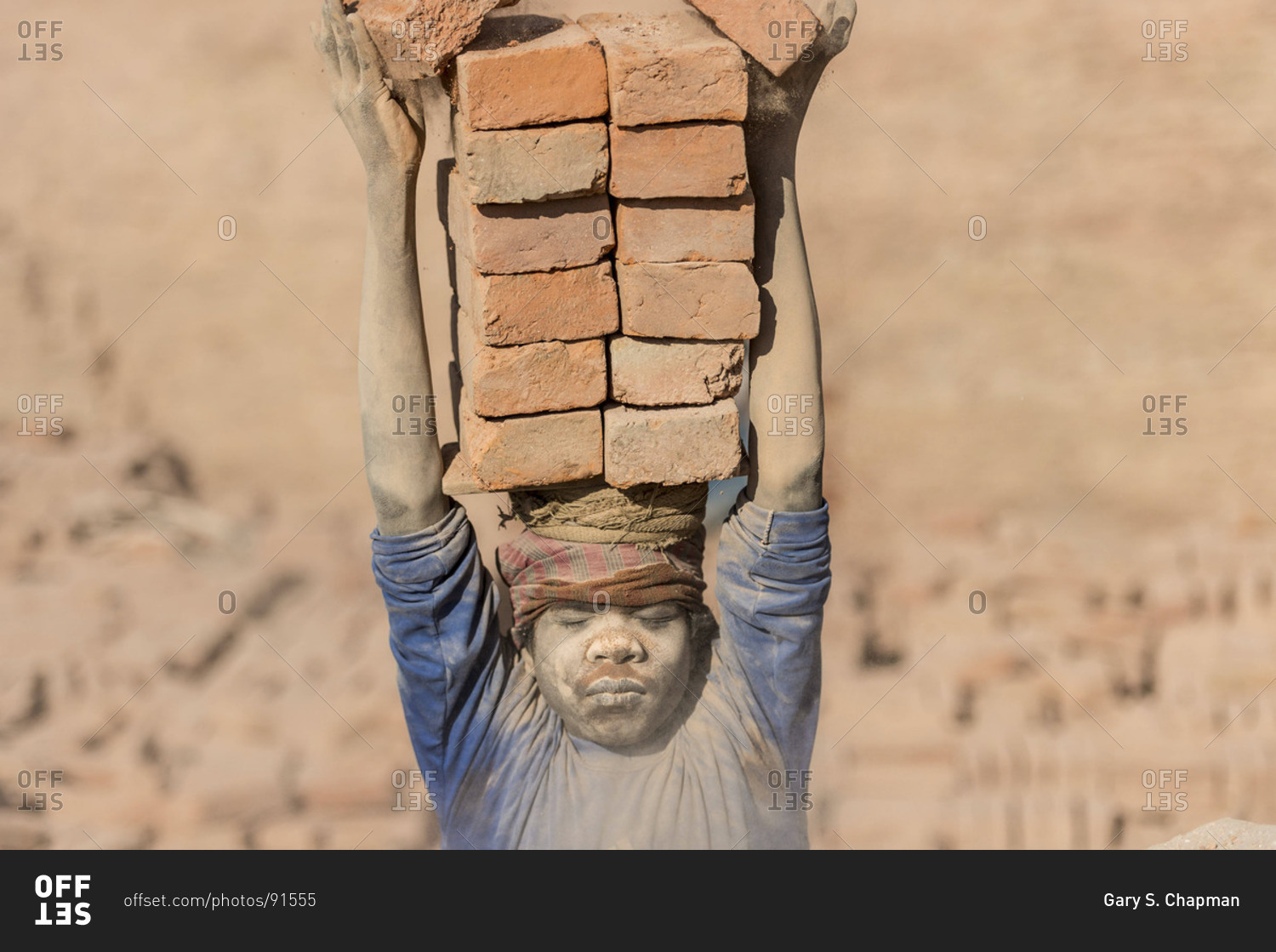 March 24, 2013 Young boy holding bricks on his head at a brick factory