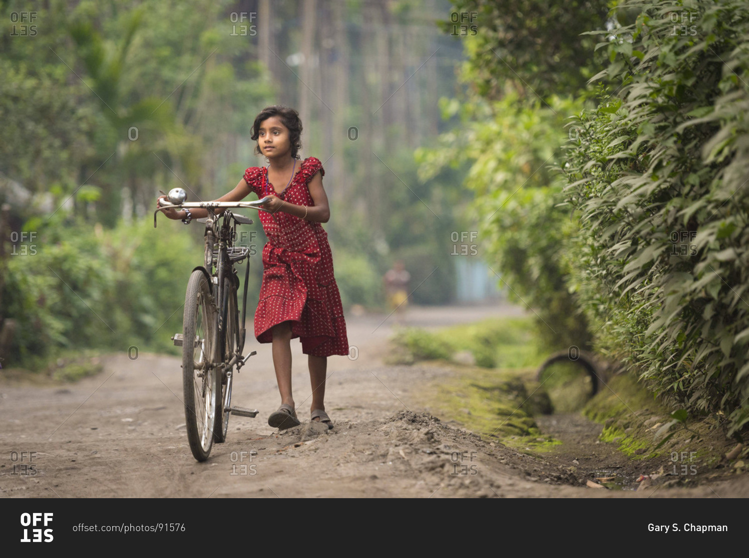 March 28 2013 Young girl pushing her bike near Lucky Village