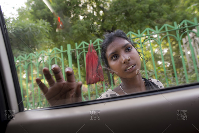 Young woman begging on the streets of Delhi, India
