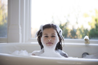 Children play in bubble bath stock photo - OFFSET
