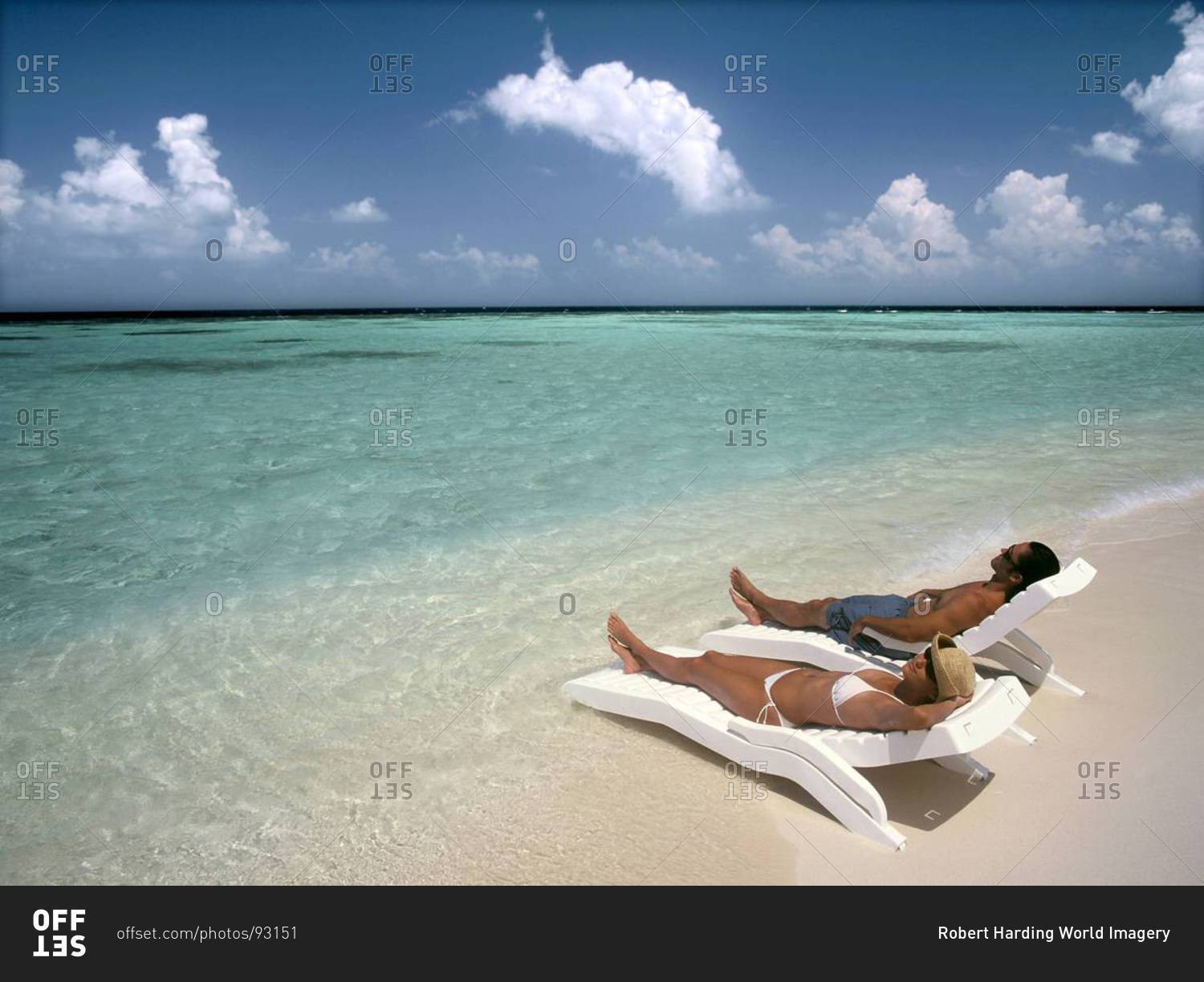 Couple sunbathing on a beach, Maldives, Indian Ocean, Asia