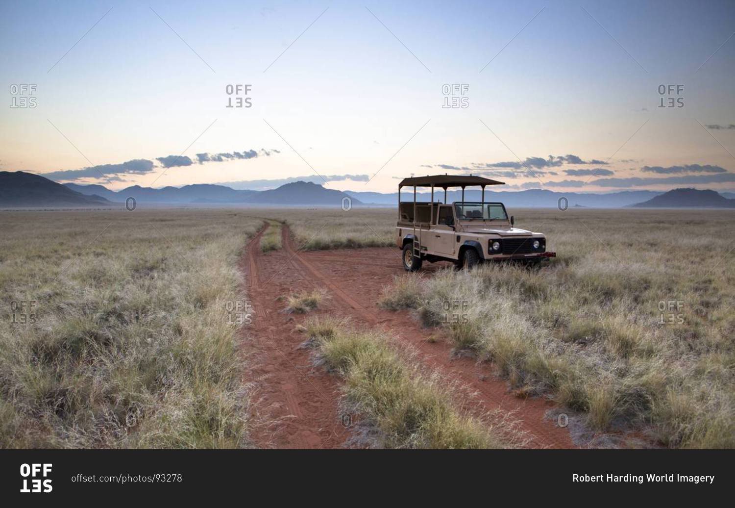 Land Rover game vehicle parked by sand road at sunrise, Namib Rand game reserve, Namib Naukluft Park, Namibia, Africa