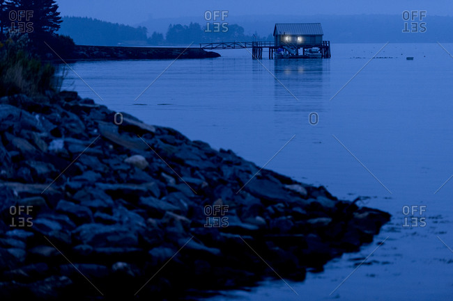 A boat house at twilight near New Harbor, Maine