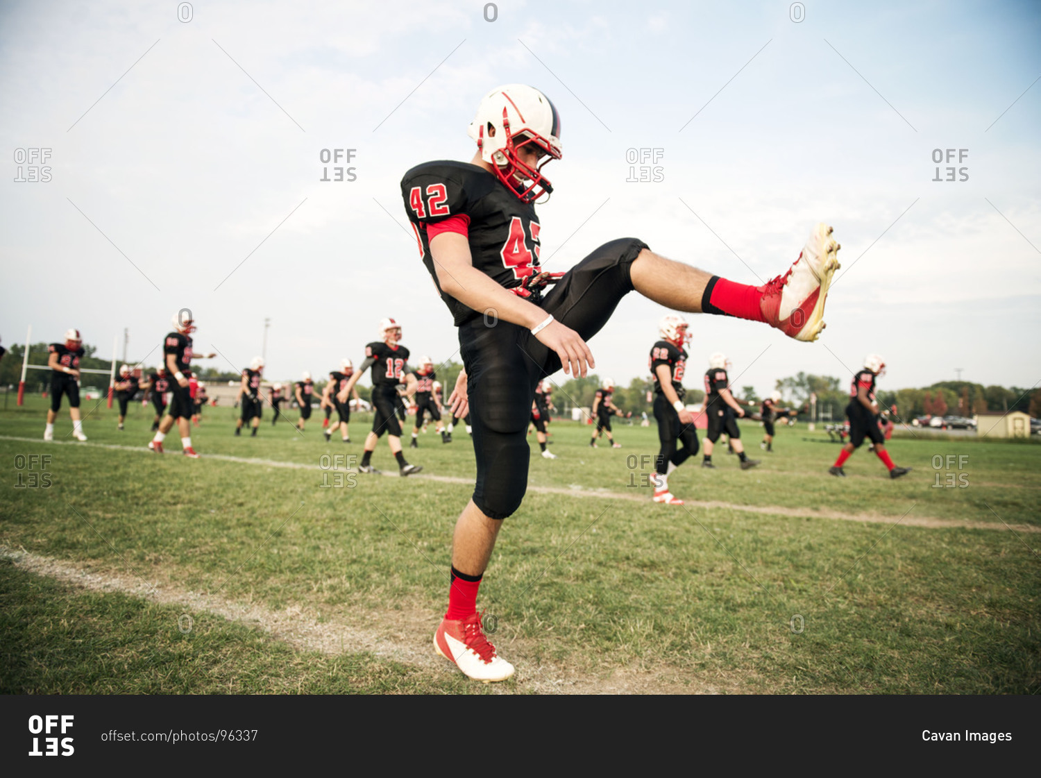 Football kicker warming up his leg