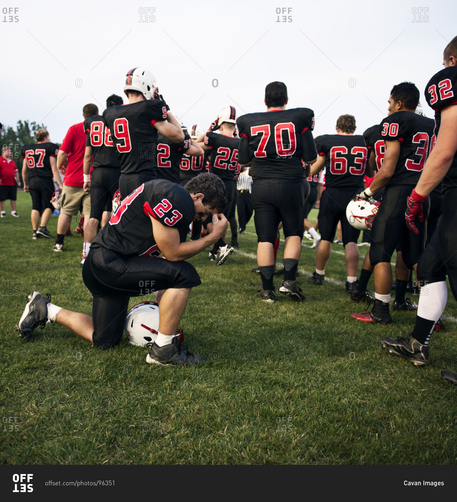 Football player praying before the game